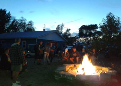 People gathered about communal fire pit